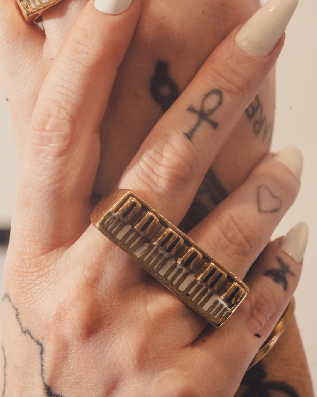 A custom gold piano ring worn on the hand